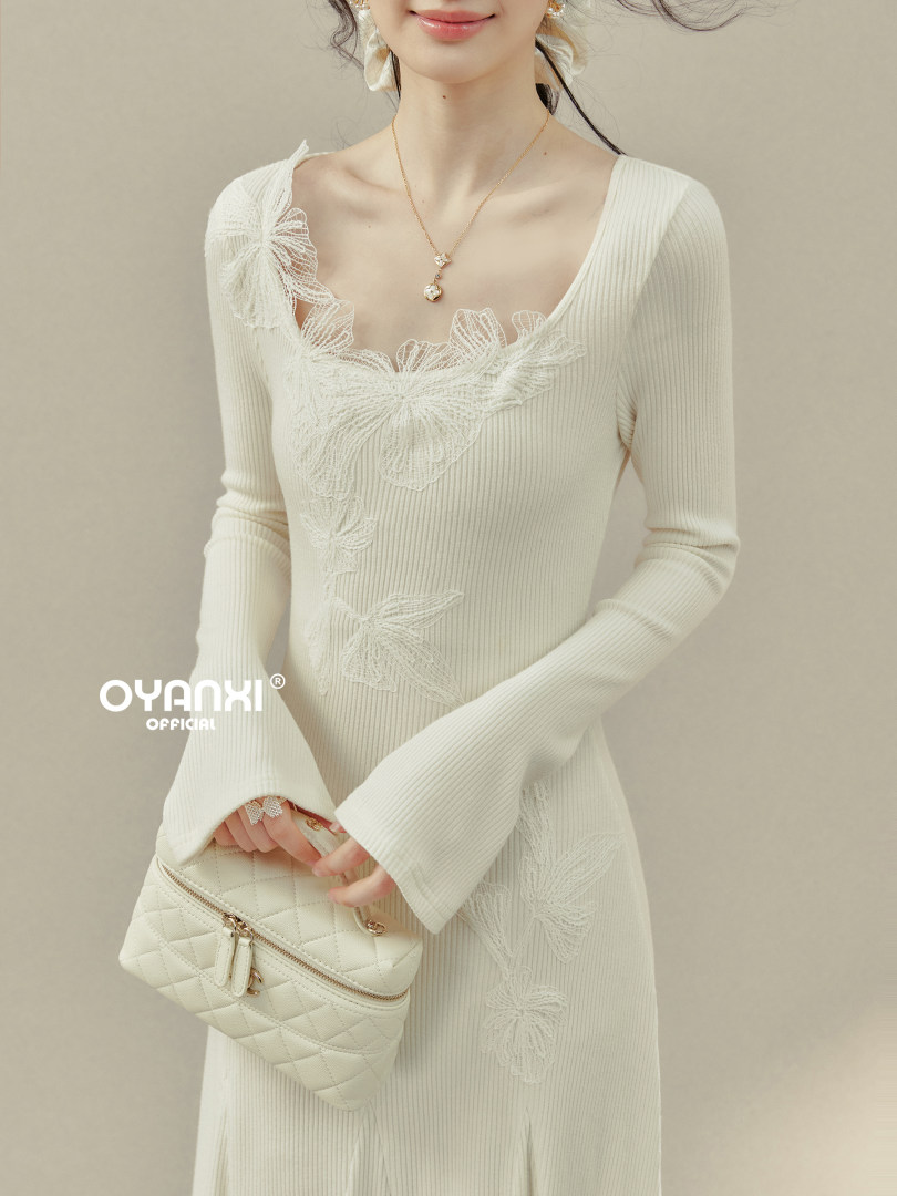 Cream ribbed long-sleeve dress with floral lace appliqué on a model