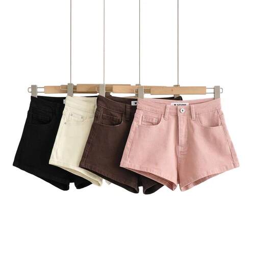 Women's high waisted long denim shorts with visible legs,