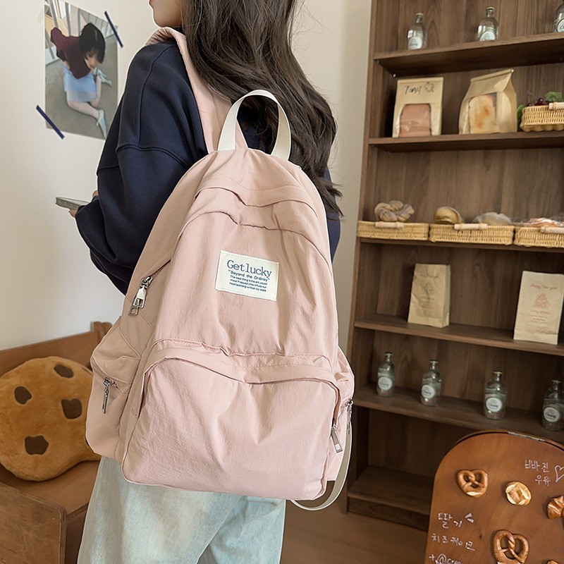 背包女士2026新款双肩书包女大容量高中学生初中生简约纯色背包大