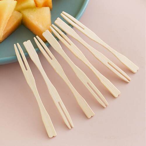 A set of disposable fruit forks for home use, featuring a cr