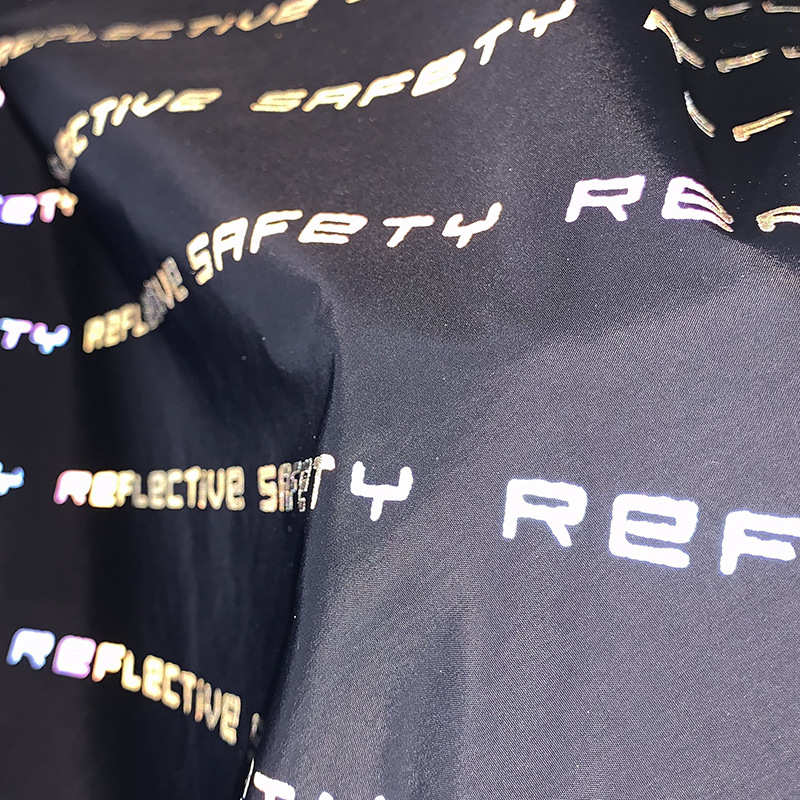 厂家直供七彩反光布料印花面料发光布炫彩幻彩夜光字母面料反光布