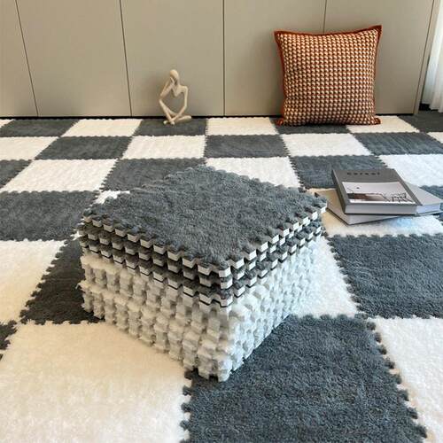Plush carpet by the bed and foam floor mat in the bedroom