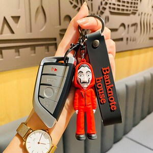 现货跨境热销纸钞屋钥匙扣外贸款惊悚公仔包包挂件汽车小礼品摆件