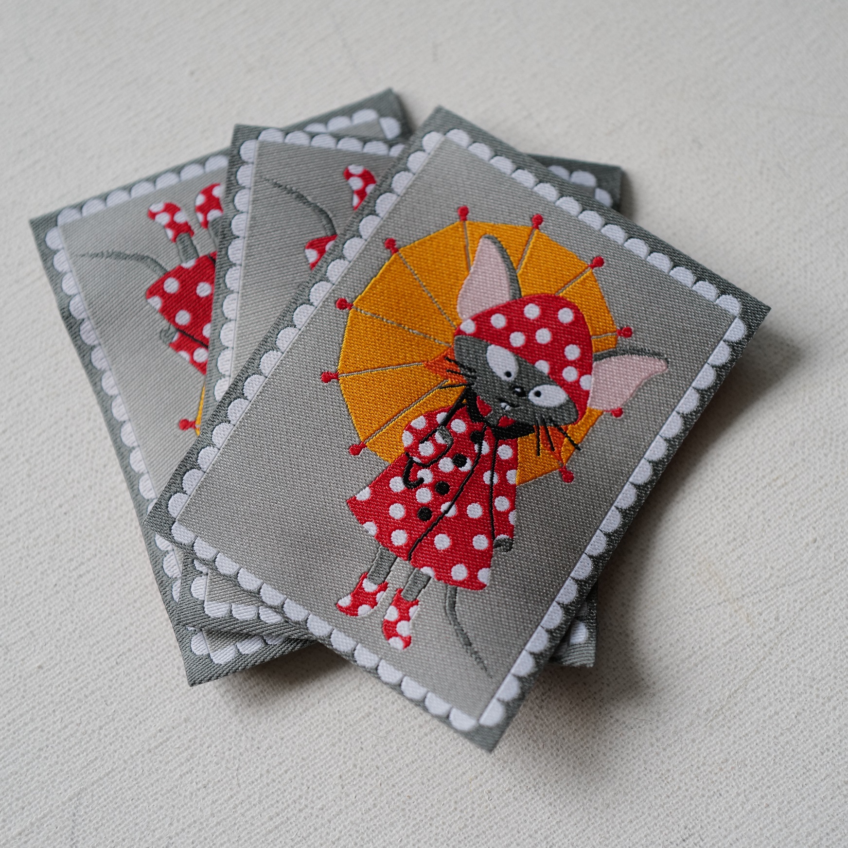 58mm宽75mm高一枚价英国textile garden穿波点雨衣撑伞的猫织唛