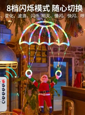 Hanging of Santa Claus parachutes on the Christmas tree