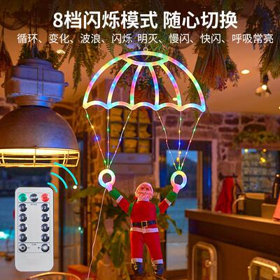 Hanging of Santa Claus parachutes on the Christmas tree