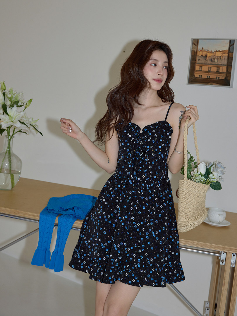 Woman modeling a black floral spaghetti-strap mini dress