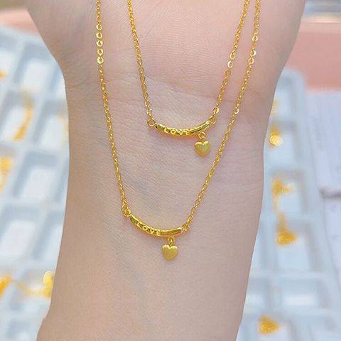 黄金色轻奢高级感微笑INS风项链女新款LOVE字母吊坠桃心锁骨套链