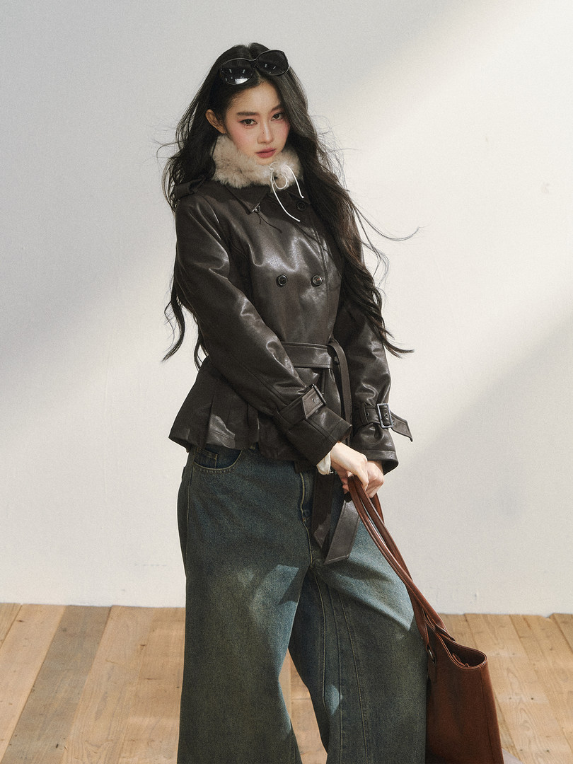 Model wearing a dark brown leather jacket with a fur collar and wide-leg jeans
