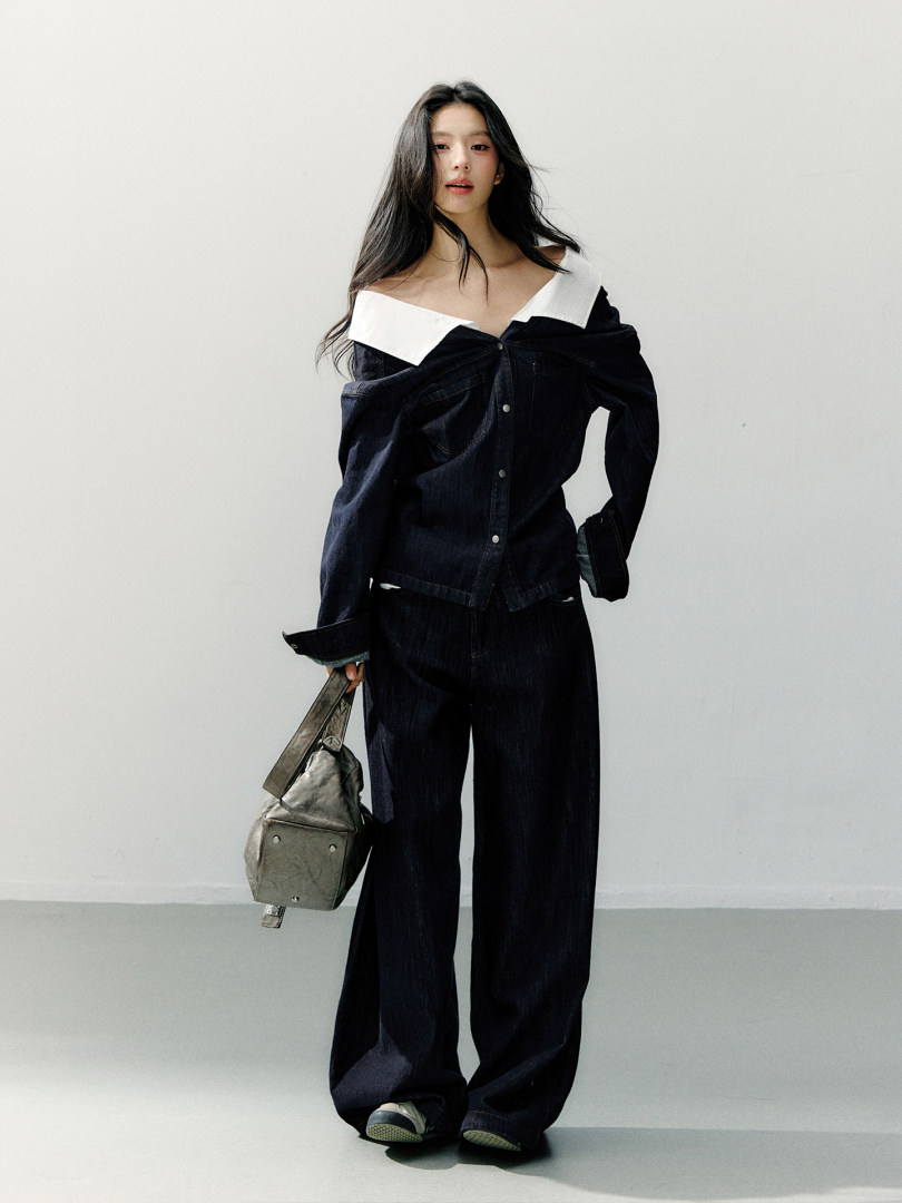 Model wearing a dark denim off-shoulder top with matching wide-leg pants