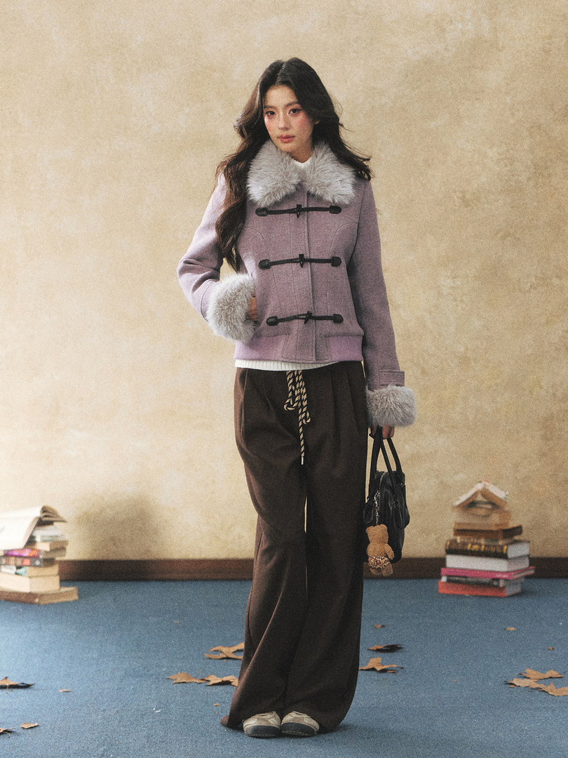 Woman wearing a lavender faux-fur trim duffle coat with dark wide-leg pants