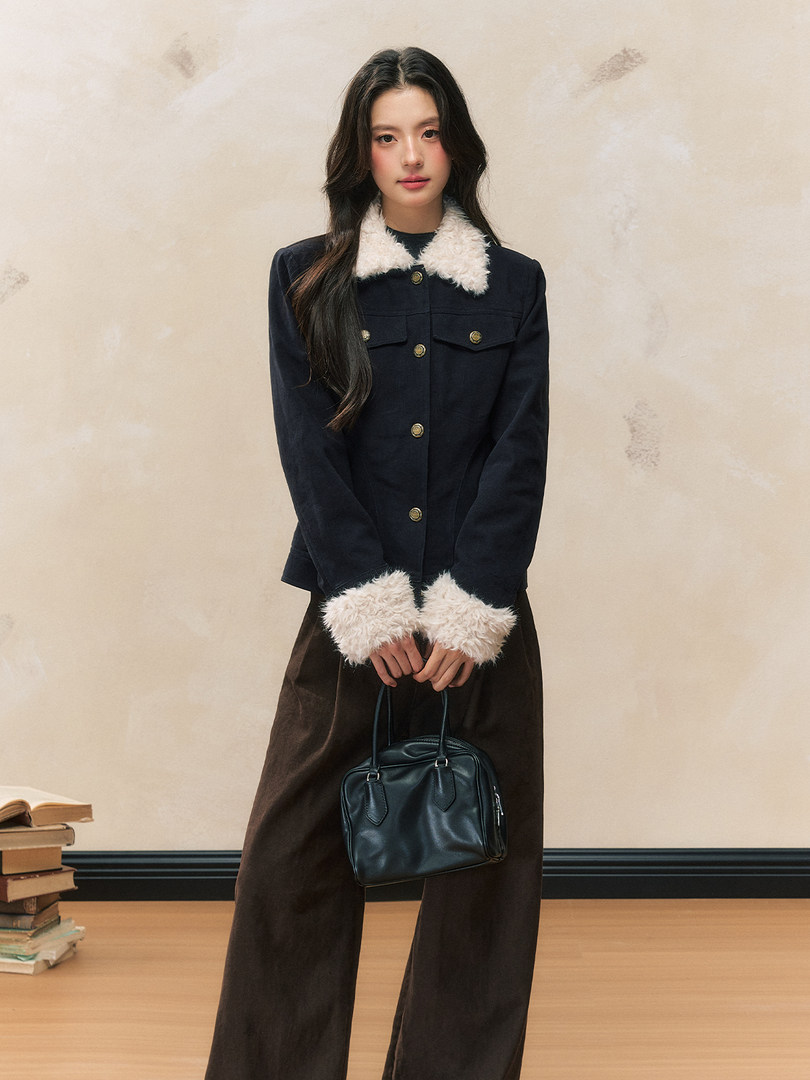 Model wearing a navy jacket with white faux fur trim and gold buttons