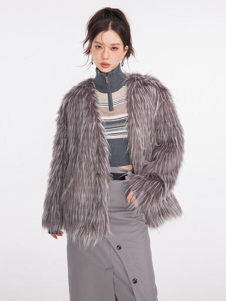 Model wearing a shaggy gray faux fur coat over a striped top and gray skirt