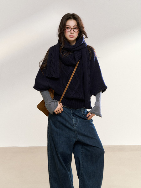 Model wearing a dark navy knit sweater and scarf with wide-leg jeans and a crossbody bag