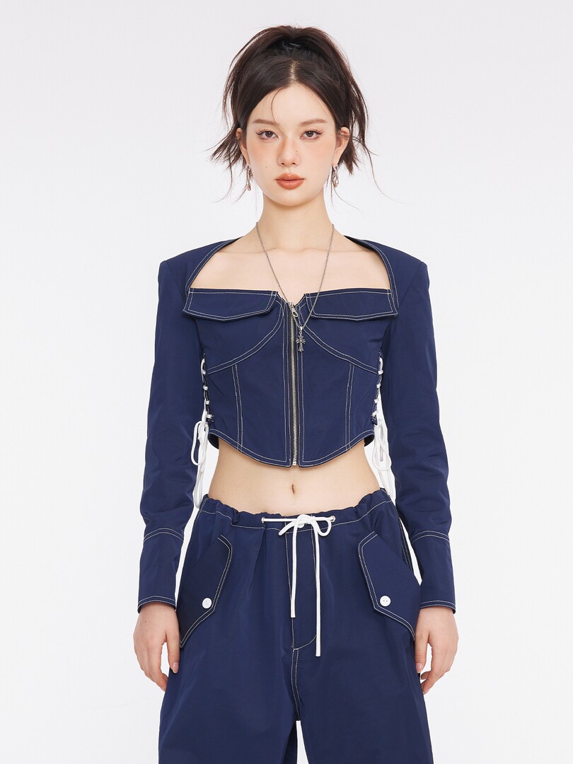 Model wearing a navy cropped top and matching pants set