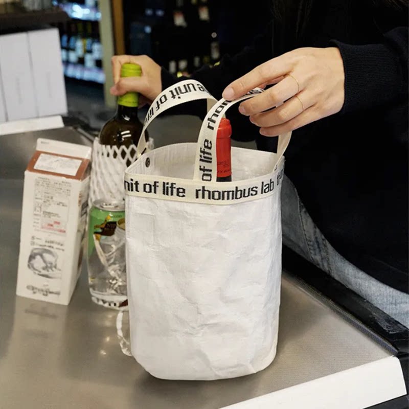 韩系水桶包小众字母百搭轻便购物旅行编织袋便当包防水洗漱收纳包