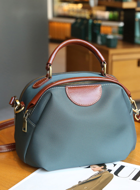 2026春夏新款牛津布配皮双拉链大容量斜挎手提包轻便简约小圆包女