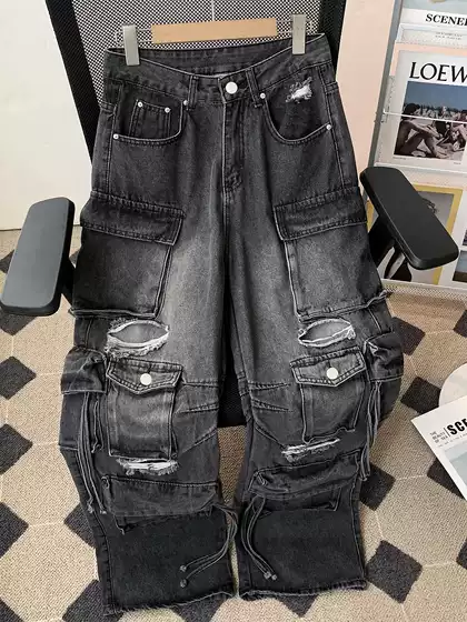 Street heavy industry multi pocket logging workwear pants for men and women with a slightly flared design, featuring holes, rough edges, and loose wide leg jeans