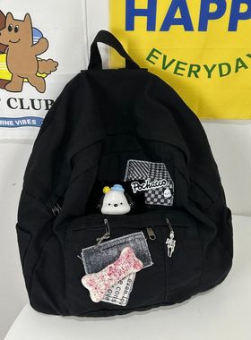 黑色幽默可爱大容量学生校园通勤实用百搭贴布黑色不规则双肩包