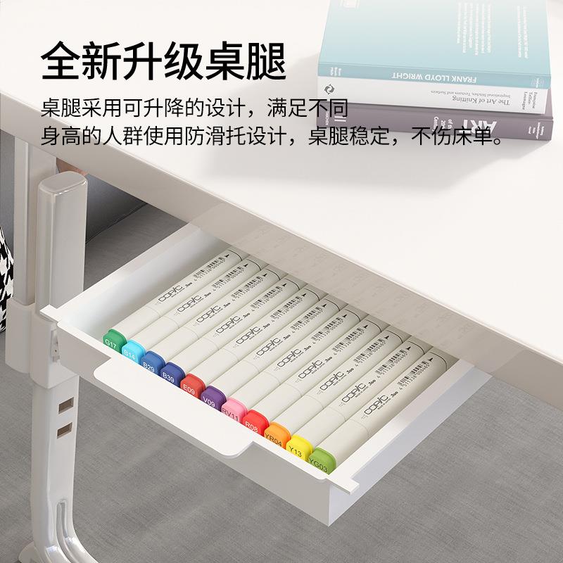 A small adjustable and foldable study desk on the bed