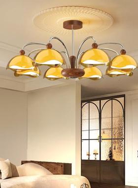 A modern, simple eye-shielded chandelier in the walnut wood-