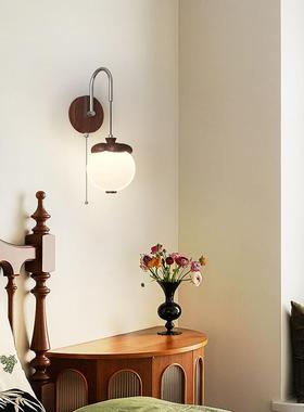 A medieval bed with a swing of arms to move the walllights.