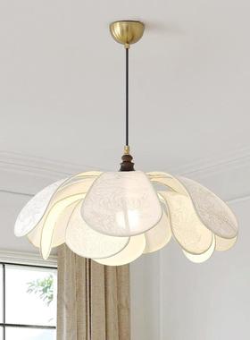 A light-freathed contour chandelier in the bedroom of the re