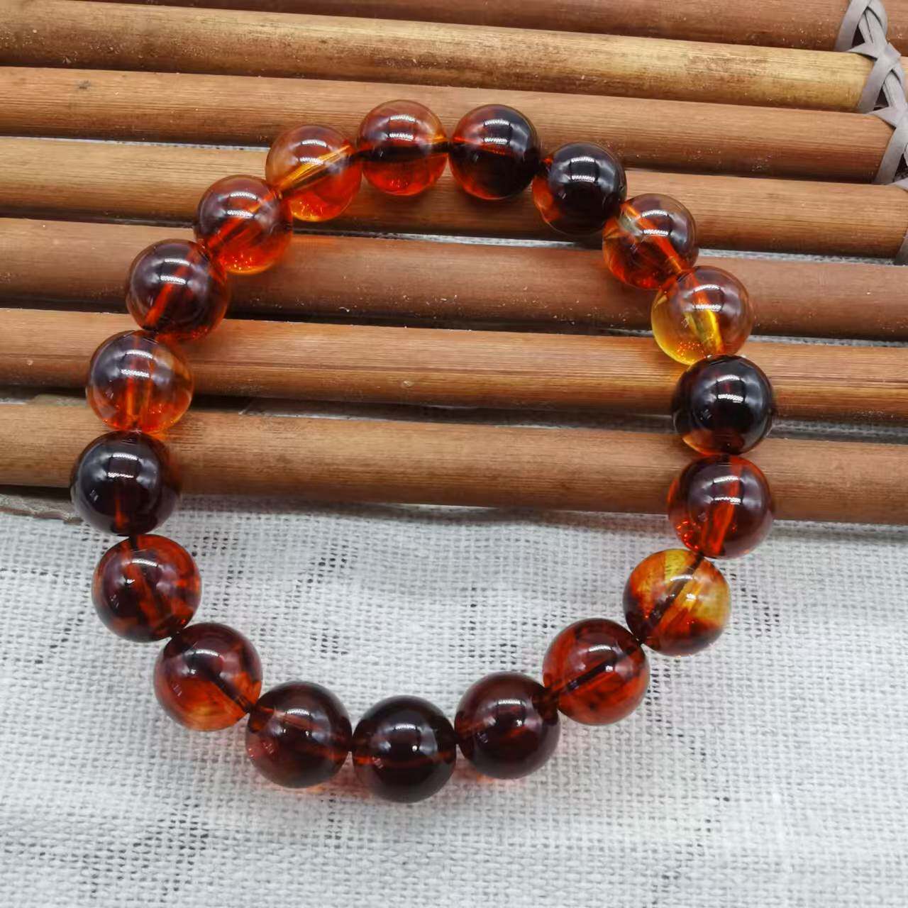 缅甸血丝珀单圈手串高仿琥珀蜜蜡树脂荧光变色手链念佛珠