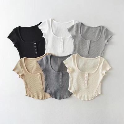 Front button reveals waist, slim hem, T-neck with exposed
