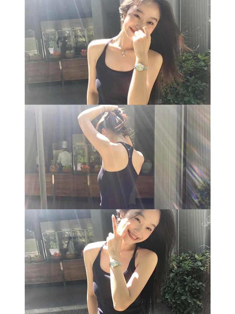 Black sleeveless tank top worn by a woman in a sunny outdoor setting