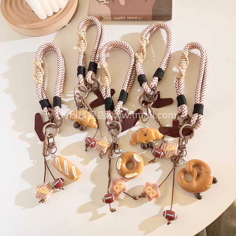 精致个性立体橄榄球牛角包饼干手机挂件百搭手提防丢手机链多功能配饰手机壳挂绳网红可爱学生女ccd便携挂链