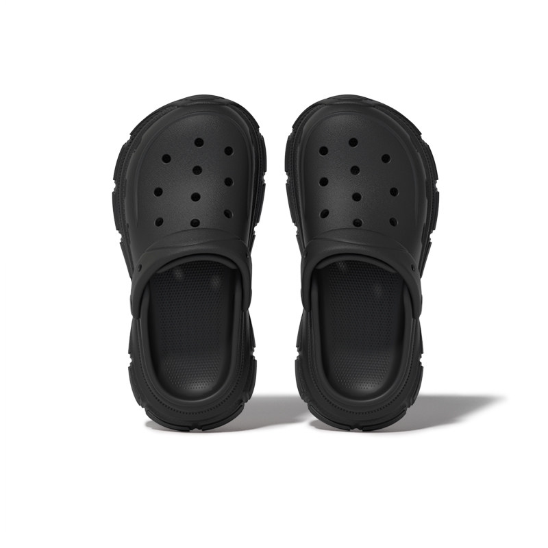 Black slip-on clogs on a white background