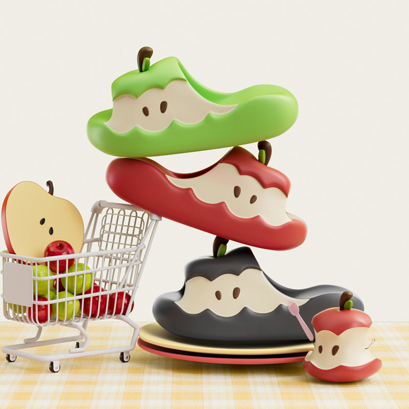 Apple-shaped novelty slippers displayed in multiple colors on a tabletop