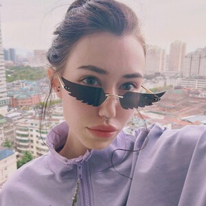 ins凹造型新款时尚炫彩猫眼太阳镜女欧美无框墨镜翅膀眼镜
