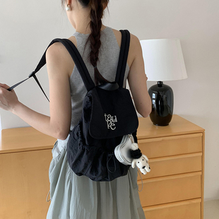 Unique blue原创刺绣字母2025抽绳翻盖双肩背包尼龙帆布学生书包