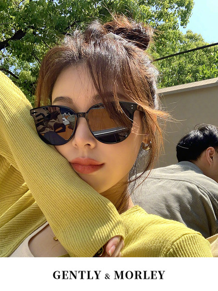 Woman wearing black cat-eye sunglasses outdoors in sunlight