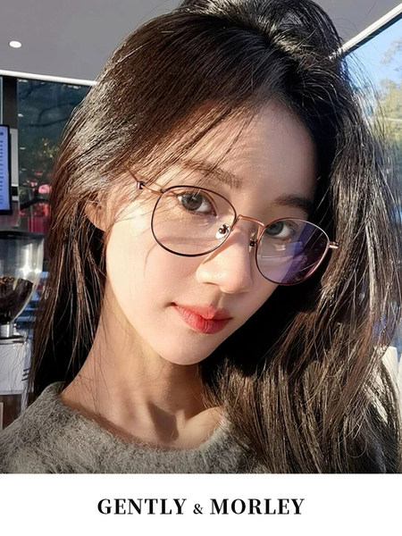 Woman wearing round eyeglasses with brand text at the bottom
