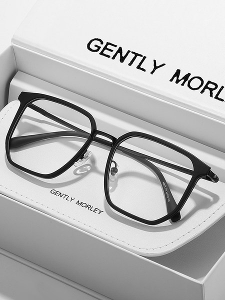 Black oversized eyeglasses displayed on a white branded box