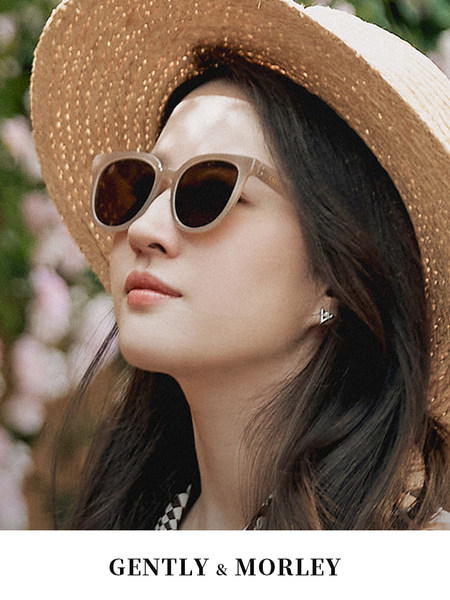 Model wearing beige sunglasses and a straw sunhat