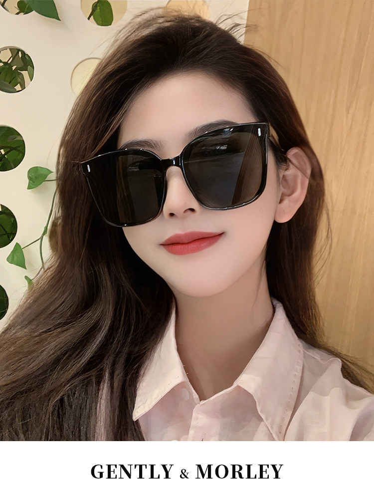 Woman wearing oversized black sunglasses