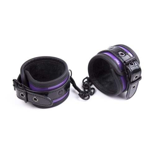 Sex toys with purple black edging, hand and foot handcuffs,