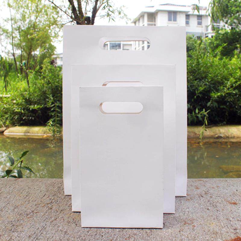 加厚白色挖空手提纸带诞包装礼无品牌/品袋礼物服店衣袋服纸带伴