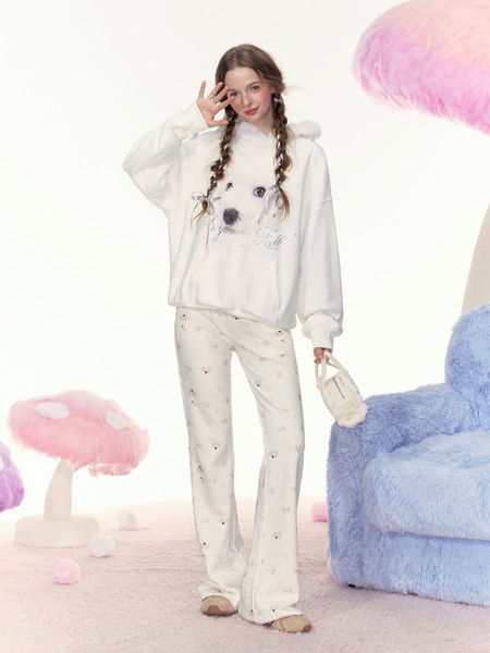 White oversized hoodie and printed lounge pants worn by a model