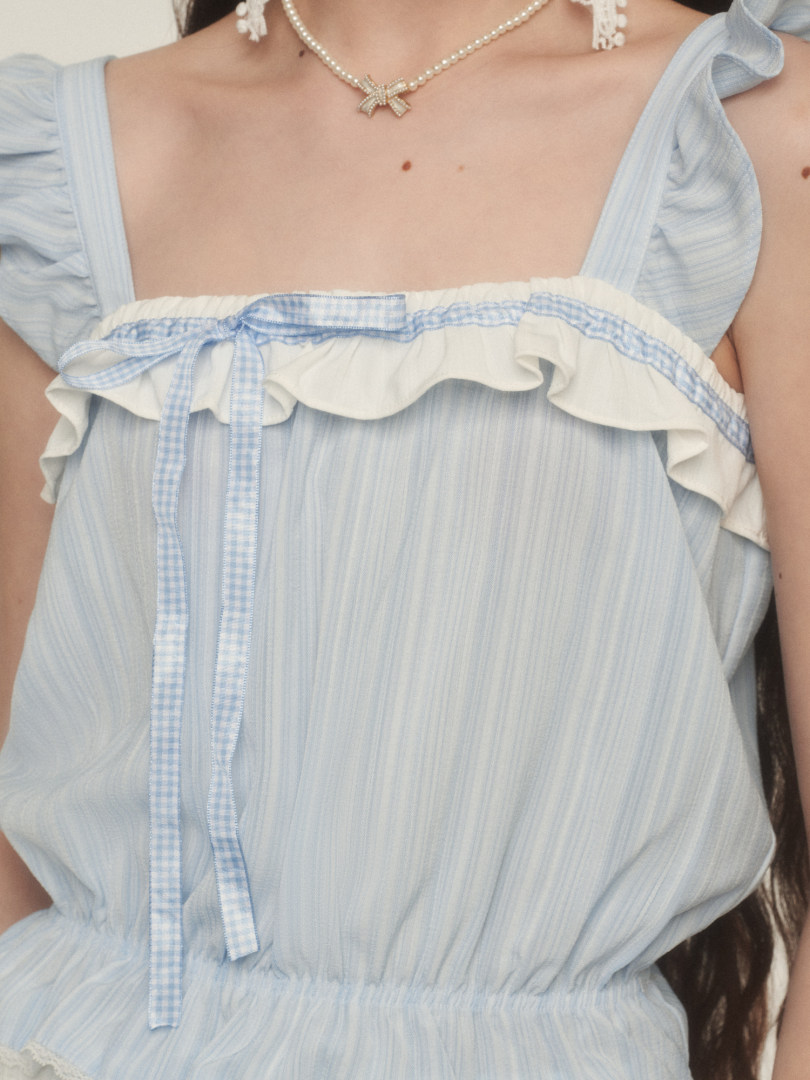 Light blue ruffled sleeveless dress worn by a model
