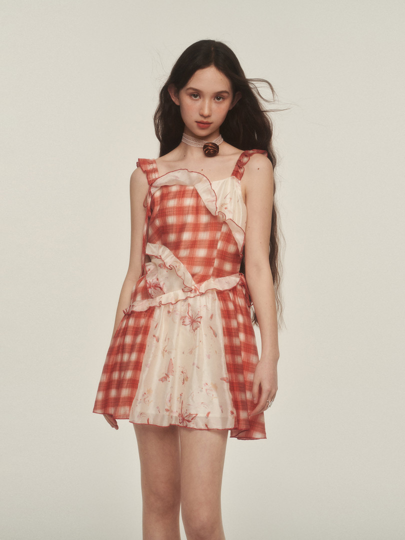 Model wearing a red plaid ruffled mini dress