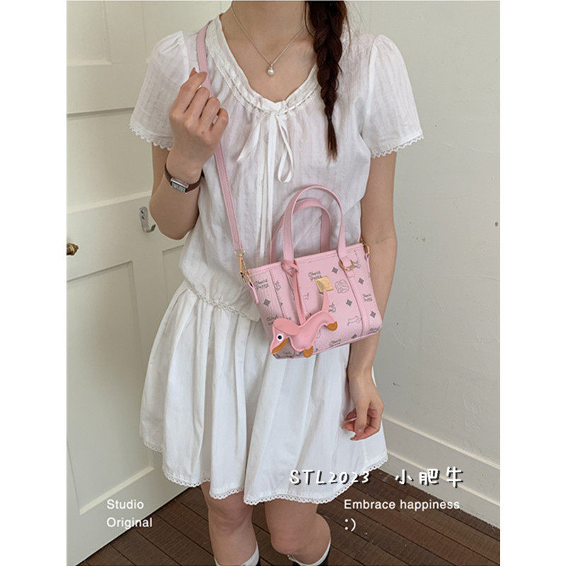 日韩少女风粉色小包包女2026新款潮卡通手提斜挎包百搭可爱水桶包