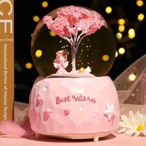 Rotating crystal ball automatically falling in the snow Love