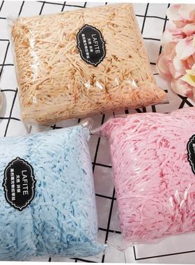 gift lined with shredded paper filling, colored packing box