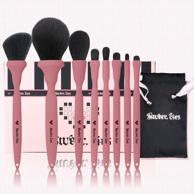 Berry makeup brushes with eye shadowed noses and powdered po