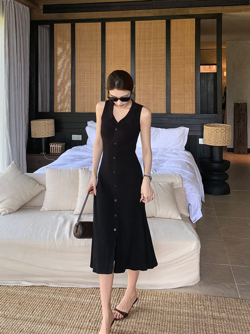 Black sleeveless button-front midi dress worn by a model indoors